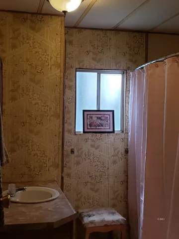 a bathroom with a sink and a mirror