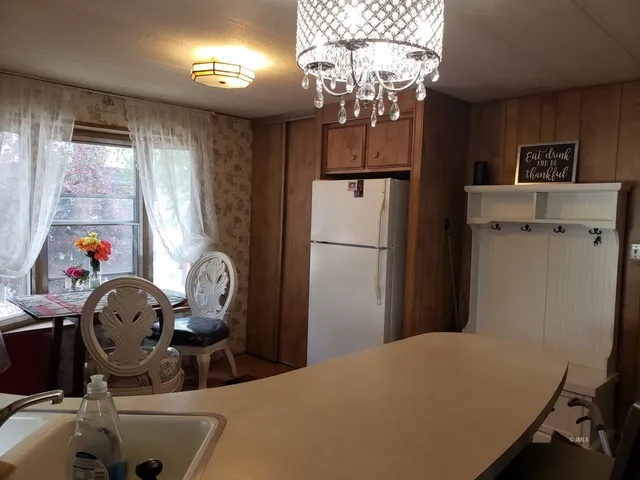 a kitchen with a table chairs and appliances