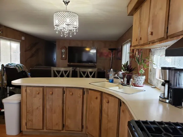 a kitchen with a stove a sink and a refrigerator