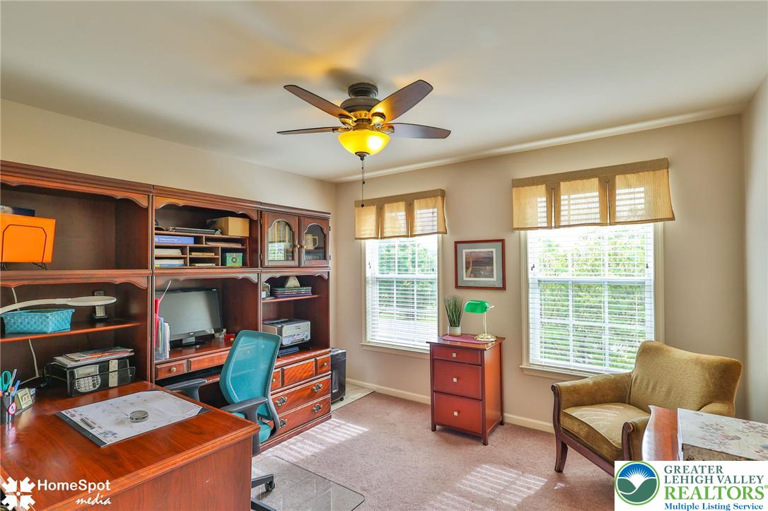 4191 Walter Road Bethlehem, PA 18020 - Photo 16 of 23 An organized home office features a built-in wooden desk unit and abundant natural light.
