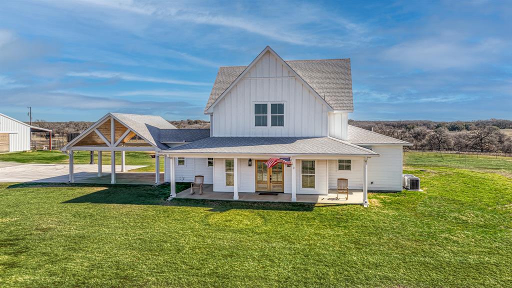 a front view of a house with a yard table and chairs