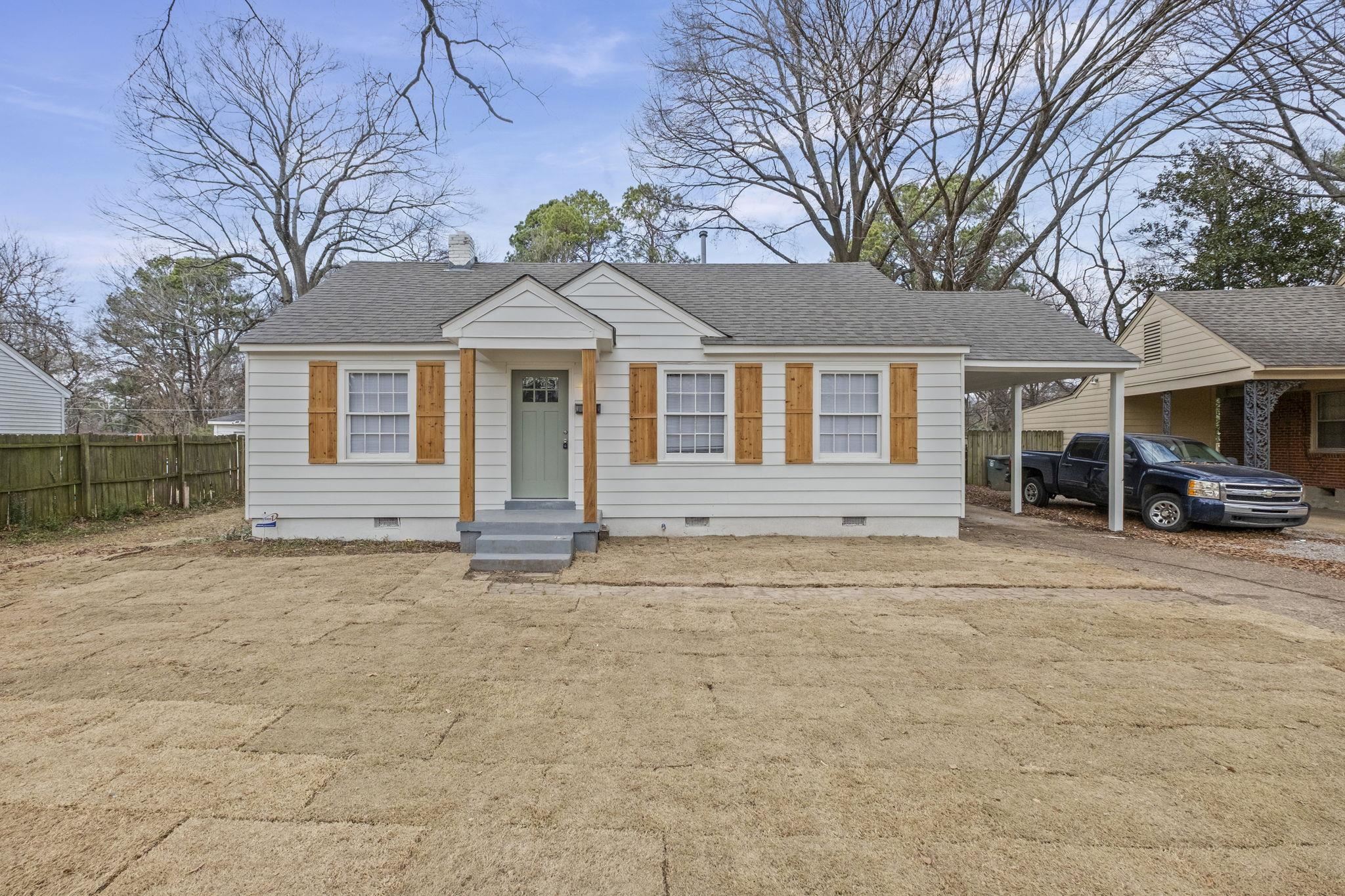 Bungalow-style house with crawl space, roof with shingles, and a carport