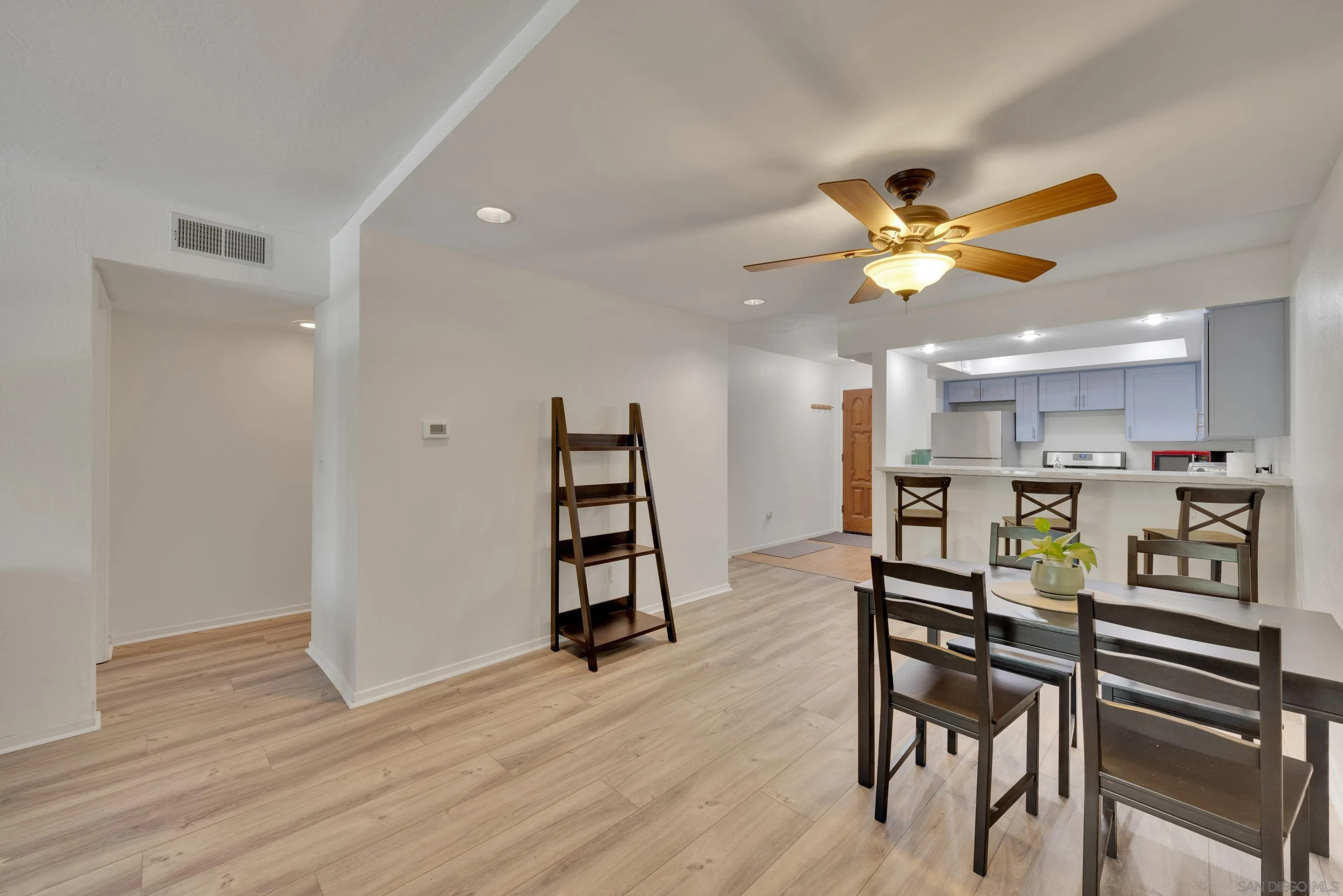 4055 Falcon Street, Unit 102 San Diego, CA 92103 - Photo 14 of 36 a view of a dining room with furniture and wooden floor