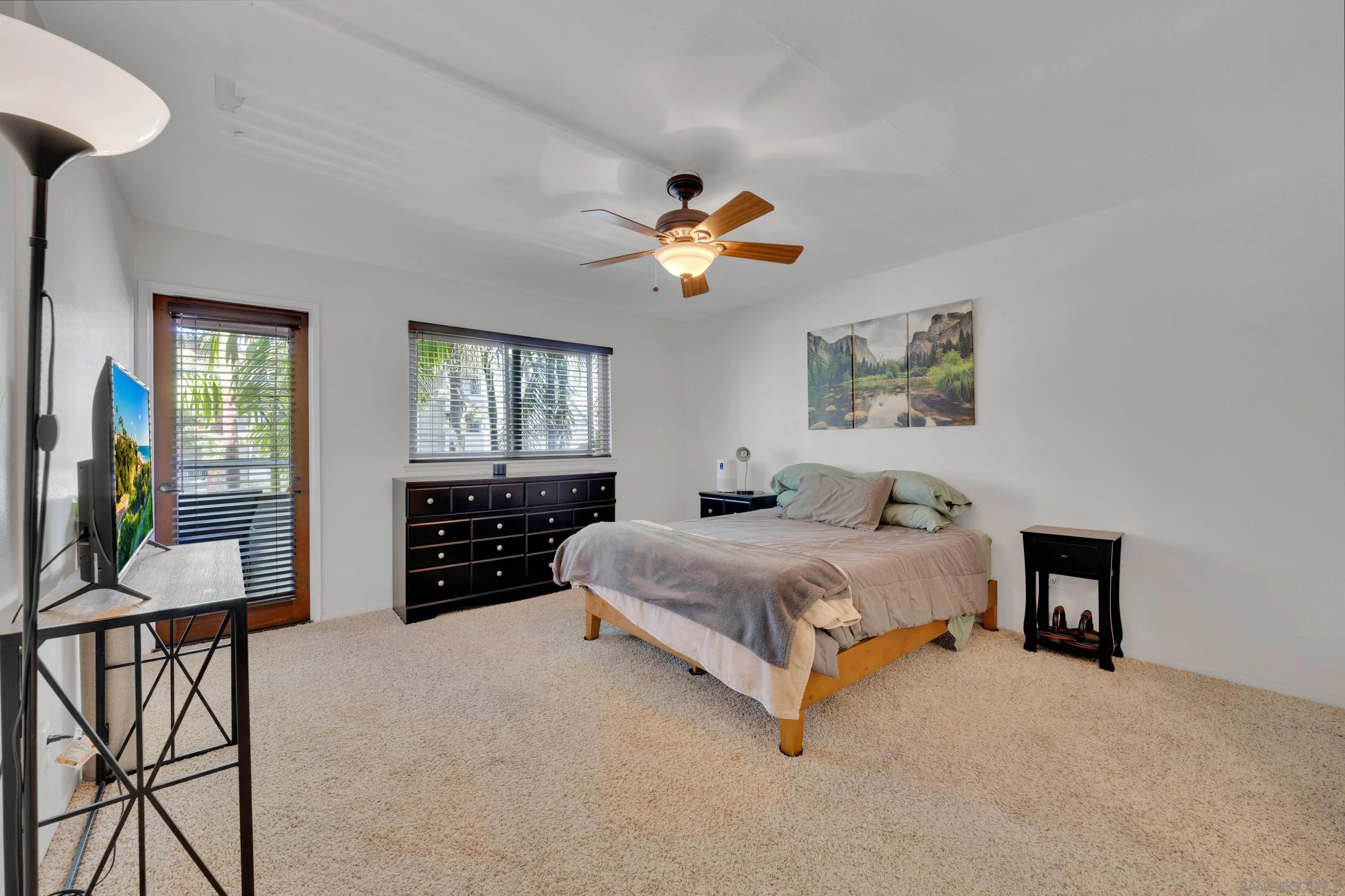 4055 Falcon Street, Unit 102 San Diego, CA 92103 - Photo 17 of 36 a bedroom with a bed and a chandelier