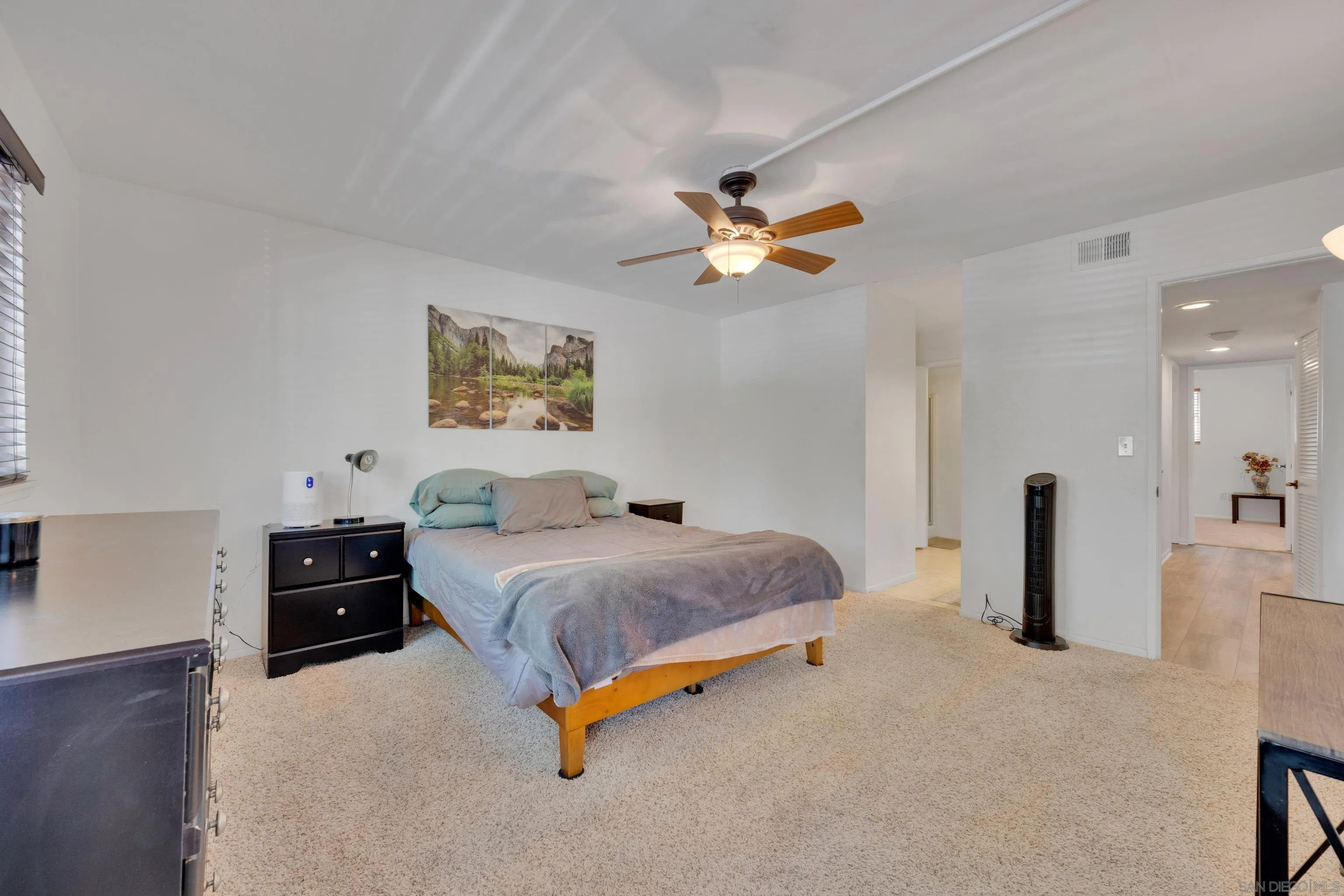 4055 Falcon Street, Unit 102 San Diego, CA 92103 - Photo 18 of 36 a bedroom with a bed and a chandelier