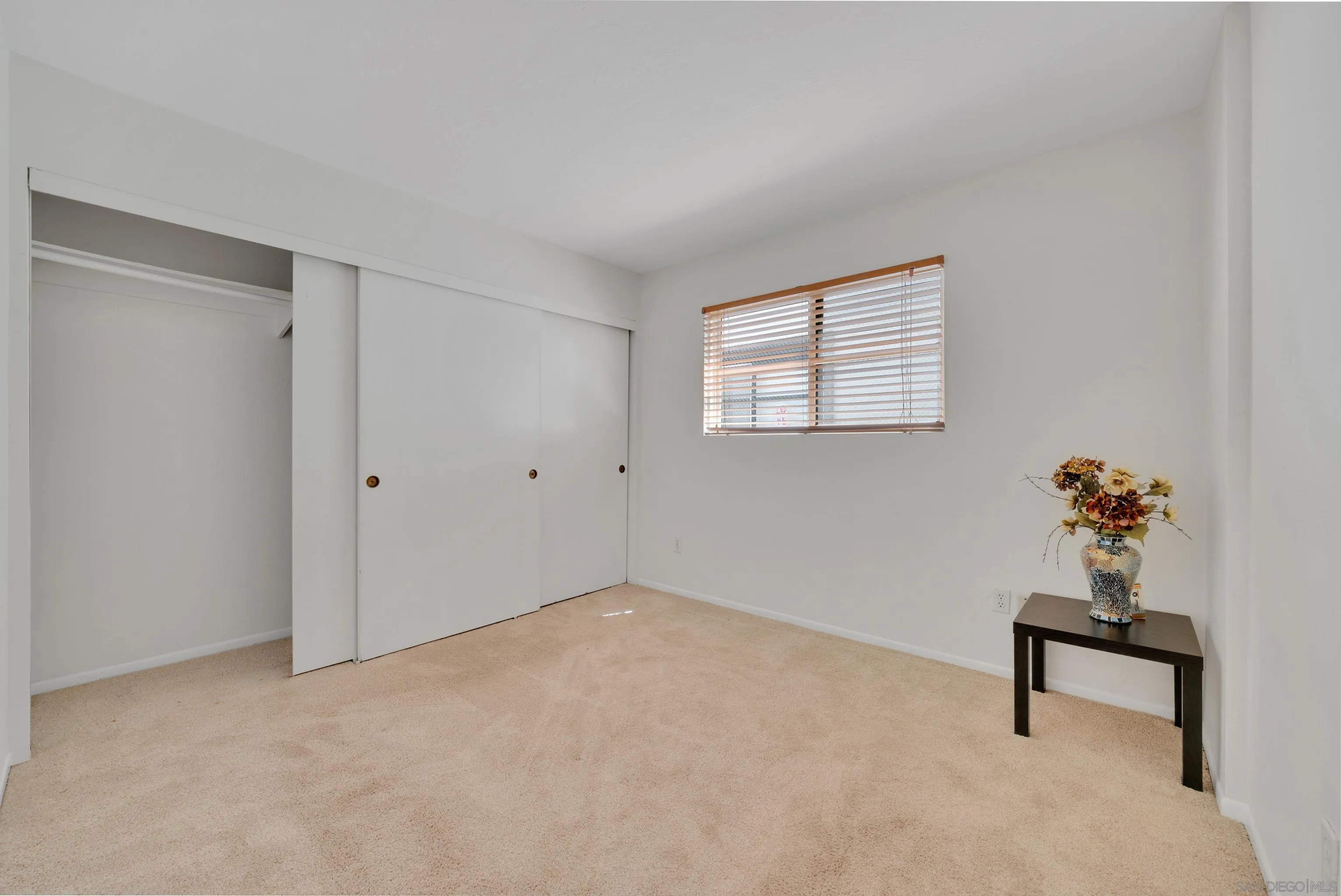 4055 Falcon Street, Unit 102 San Diego, CA 92103 - Photo 23 of 36 a hallway that has a bench and a table chair
