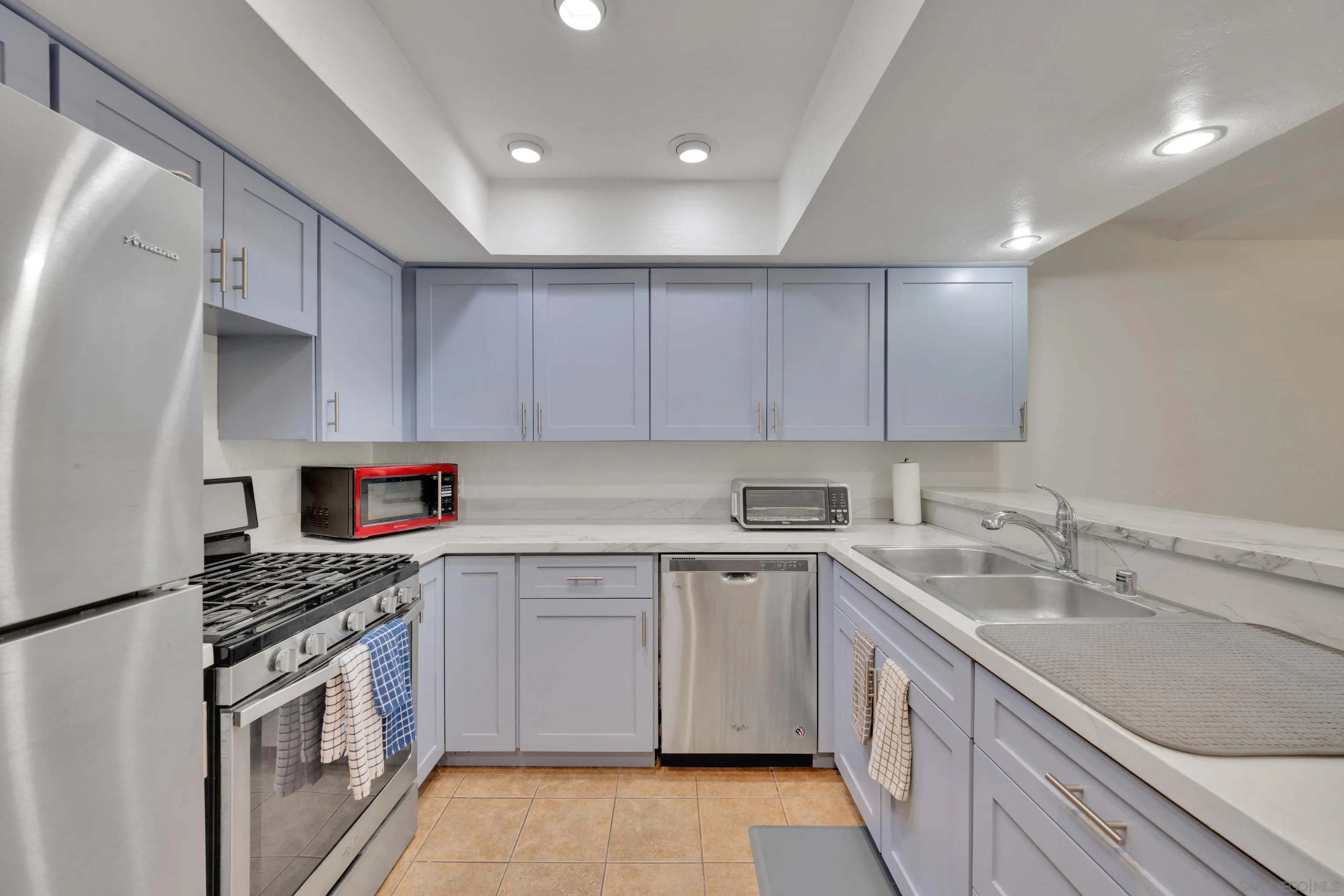 4055 Falcon Street, Unit 102 San Diego, CA 92103 - Photo 5 of 36 a kitchen with a sink stove top oven and cabinets