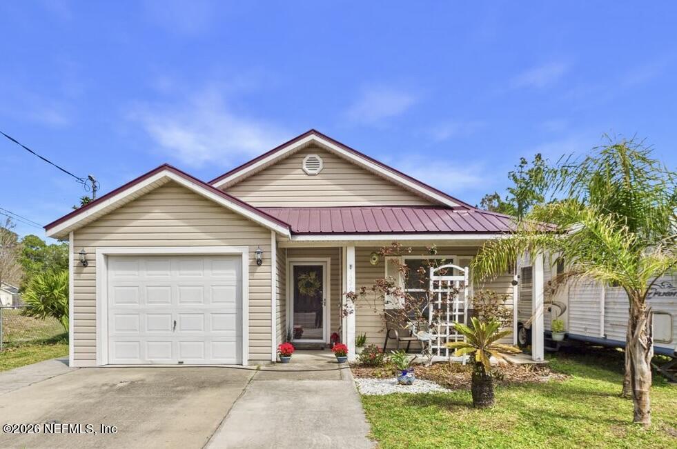 1240 4 Mile Road St. Augustine, FL 32084 - Photo 1 of 27 a front view of a house with garden