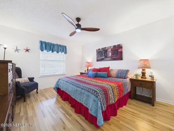 a bedroom with bed and a window