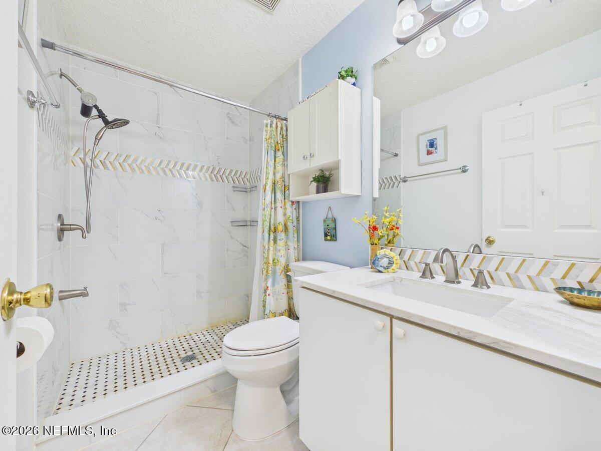 1240 4 Mile Road St. Augustine, FL 32084 - Photo 12 of 27 a bathroom with a sink toilet and shower