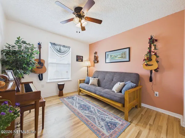 a living room with furniture and a wooden floor