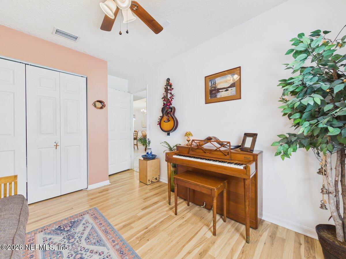 1240 4 Mile Road St. Augustine, FL 32084 - Photo 15 of 27 a living room with furniture and a potted plant