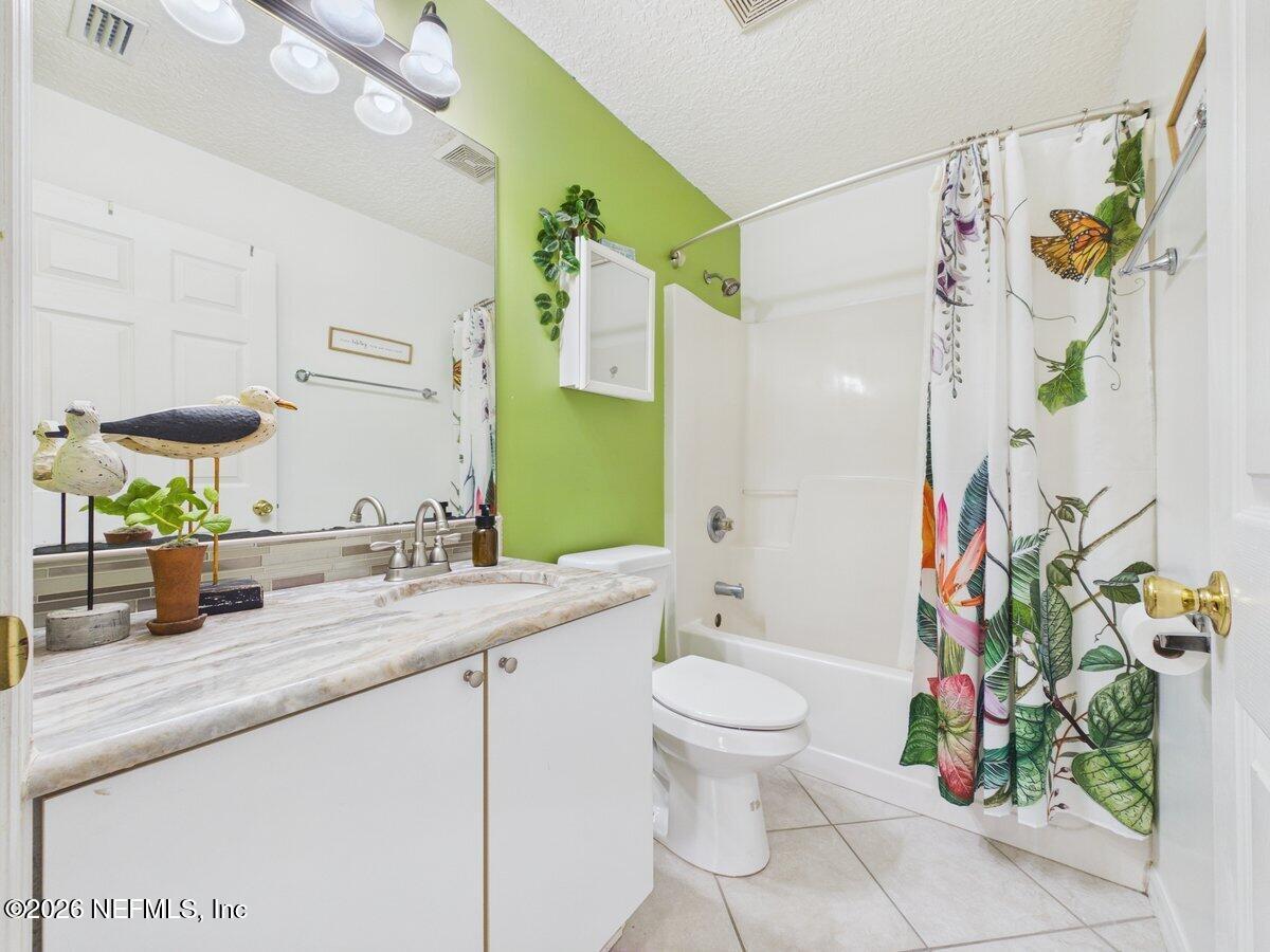 1240 4 Mile Road St. Augustine, FL 32084 - Photo 16 of 27 a bathroom with a sink a toilet and shower