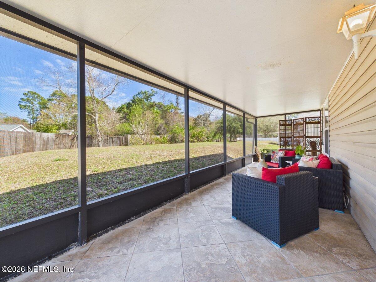 1240 4 Mile Road St. Augustine, FL 32084 - Photo 19 of 27 a living room with couch and a table