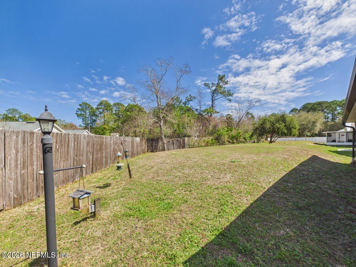 1240 4 Mile Road St. Augustine, FL 32084 - Photo 21 of 27 a view of yard with swimming pool and trees