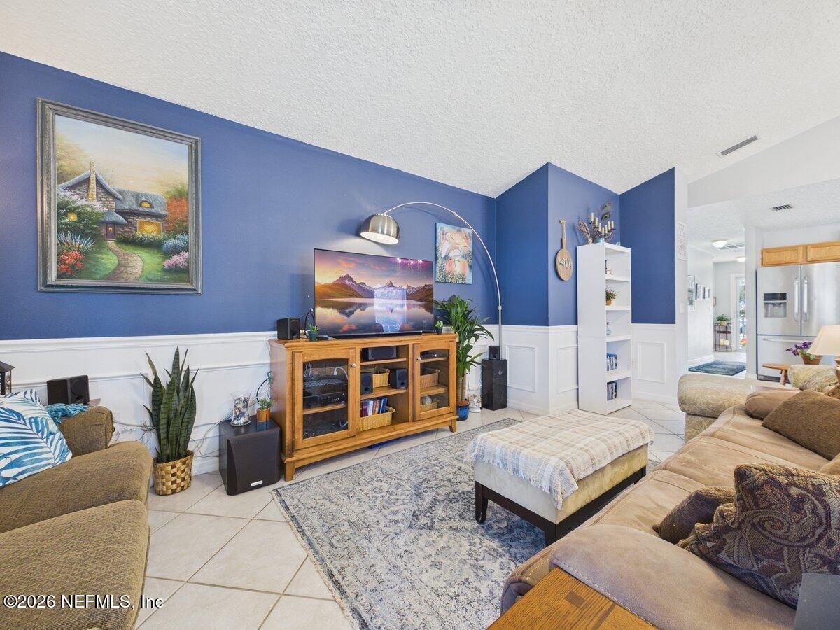 1240 4 Mile Road St. Augustine, FL 32084 - Photo 8 of 27 a living room with furniture and a fireplace
