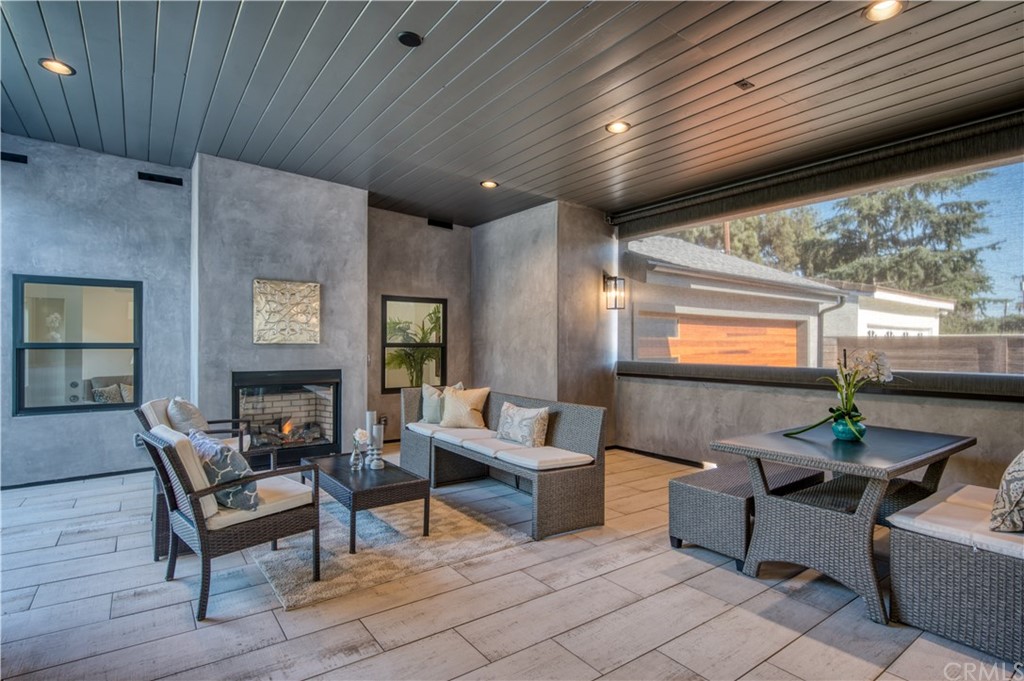 424 Esther Street Costa Mesa, CA 92627 - Photo 6 of 28 CA Room with Fireplace and Electric Privacy Awning.