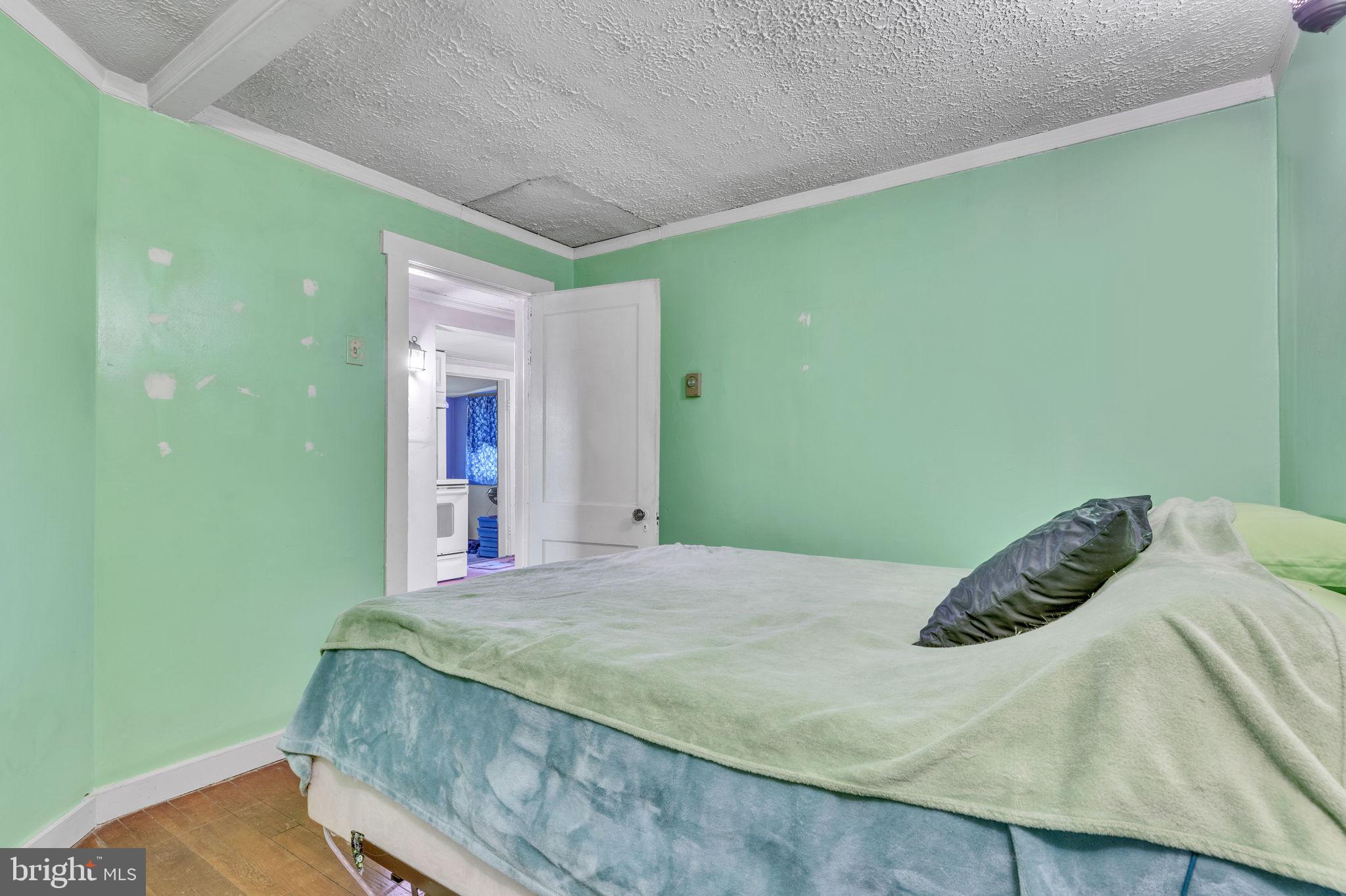 4871 Avery Road Shady Side, MD 20764 - Photo 9 of 20 a bed sitting in a bedroom next to a green space