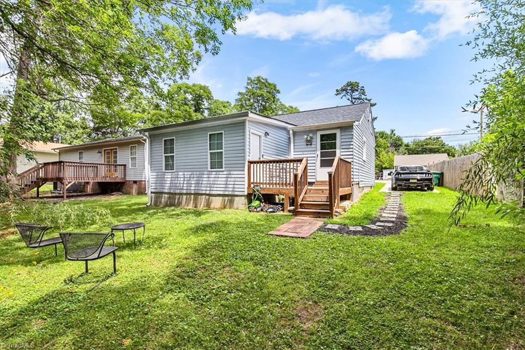 226 Friendly Avenue High Point, NC 27260 - Photo 32 of 38 Additional space is available at the rear of the property for parking, along with easy access to the primary suite and backyard.