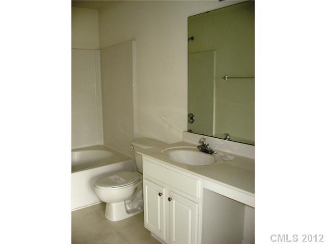 733 Shellstone Place, Unit 733 Fort Mill, SC 29708 - Photo 11 of 16 a bathroom with a granite countertop toilet a sink and a mirror