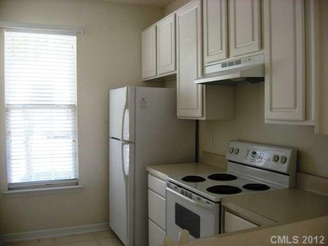733 Shellstone Place, Unit 733 Fort Mill, SC 29708 - Photo 4 of 16 a kitchen with stainless steel appliances granite countertop white cabinets and a stove