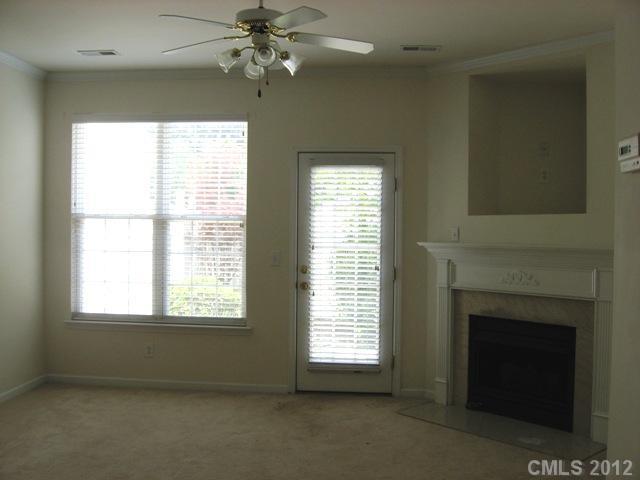 733 Shellstone Place, Unit 733 Fort Mill, SC 29708 - Photo 7 of 16 an empty room with windows and fireplace
