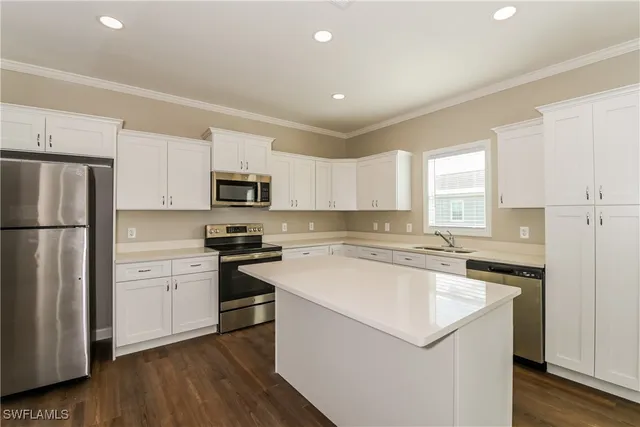 a kitchen with a refrigerator stove and microwave