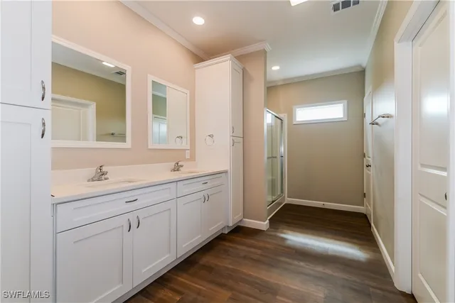 a bathroom with a double vanity sink and mirror