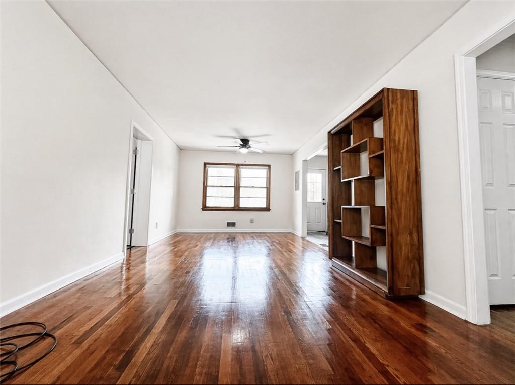 119 Fifth Avenue Jonesboro, GA 30236 - Photo 6 of 29 an empty room with wooden floor and windows