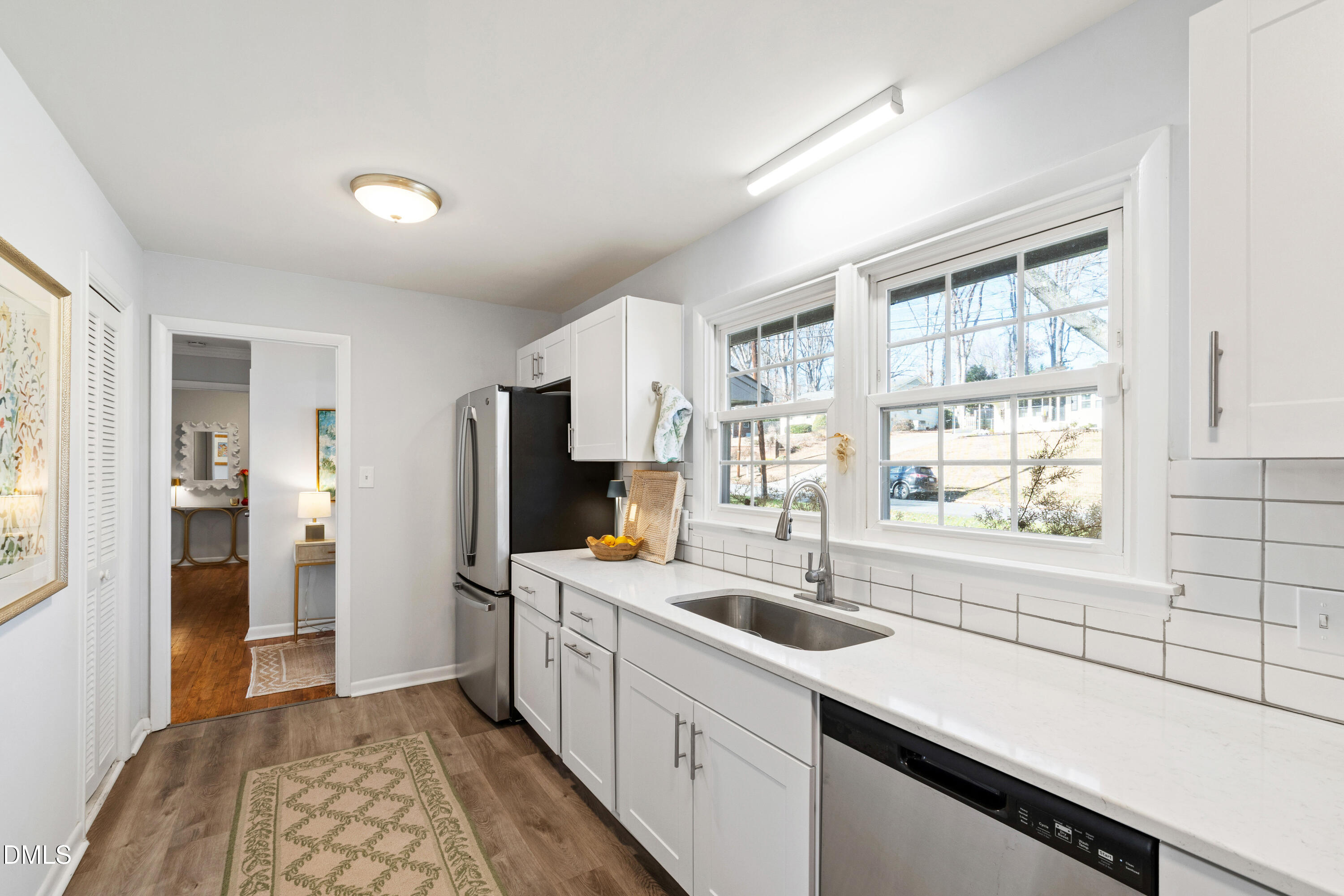 211 Northfield Drive Raleigh, NC 27609 - Photo 13 of 49 a kitchen with a sink a counter top space stainless steel appliances cabinets and a window