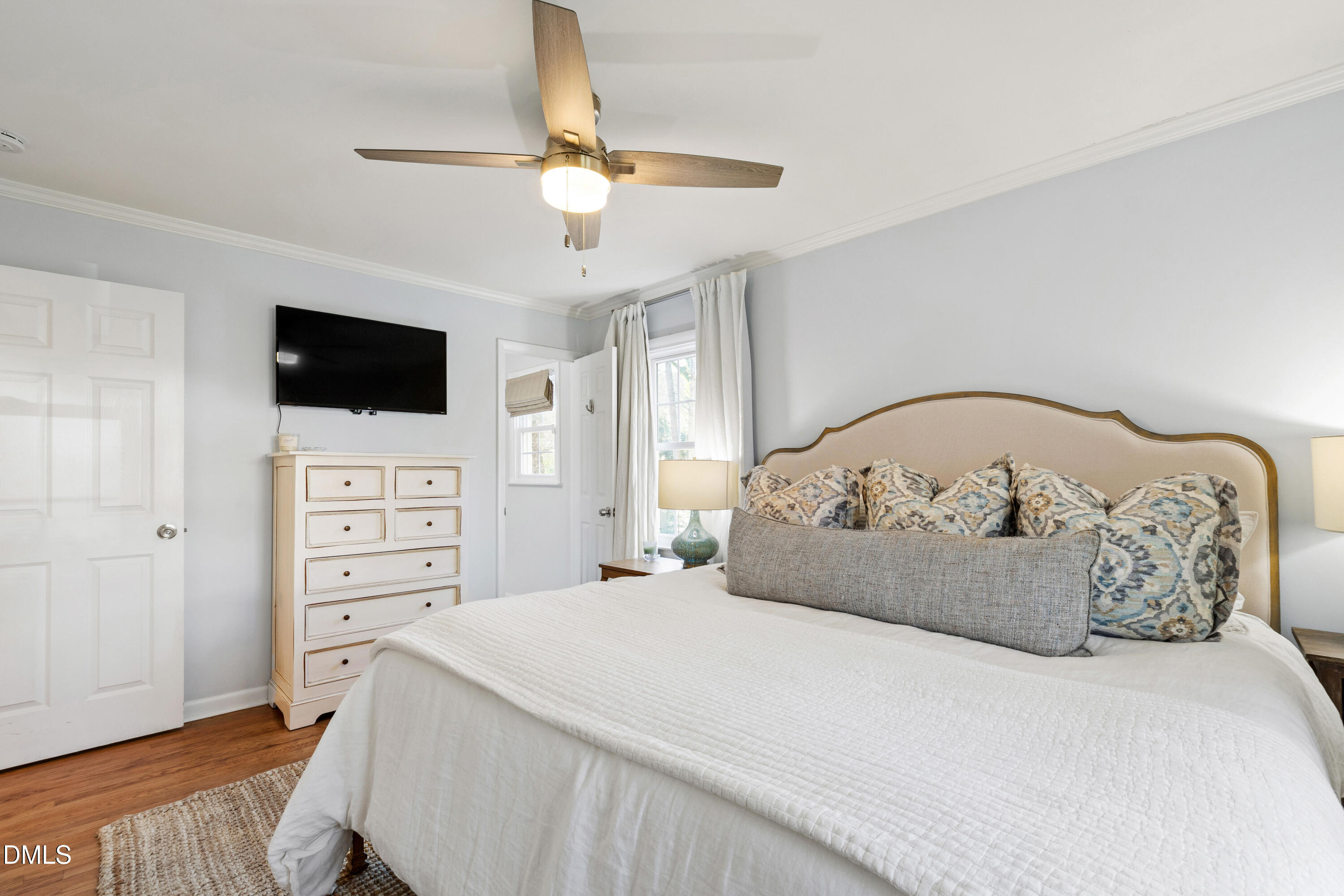 211 Northfield Drive Raleigh, NC 27609 - Photo 18 of 49 a bedroom with a bed and a flat screen tv