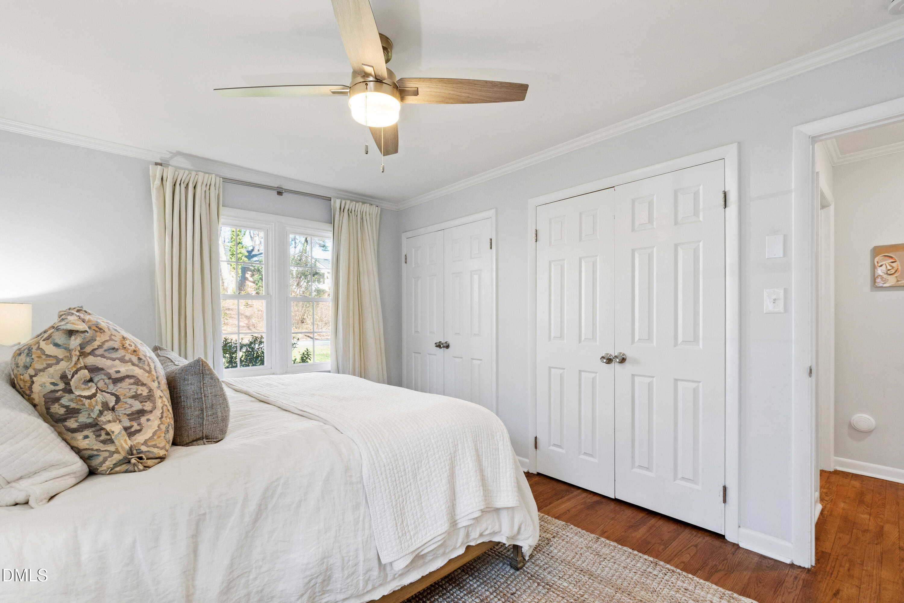 211 Northfield Drive Raleigh, NC 27609 - Photo 19 of 49 a bedroom with a large bed and a chandelier