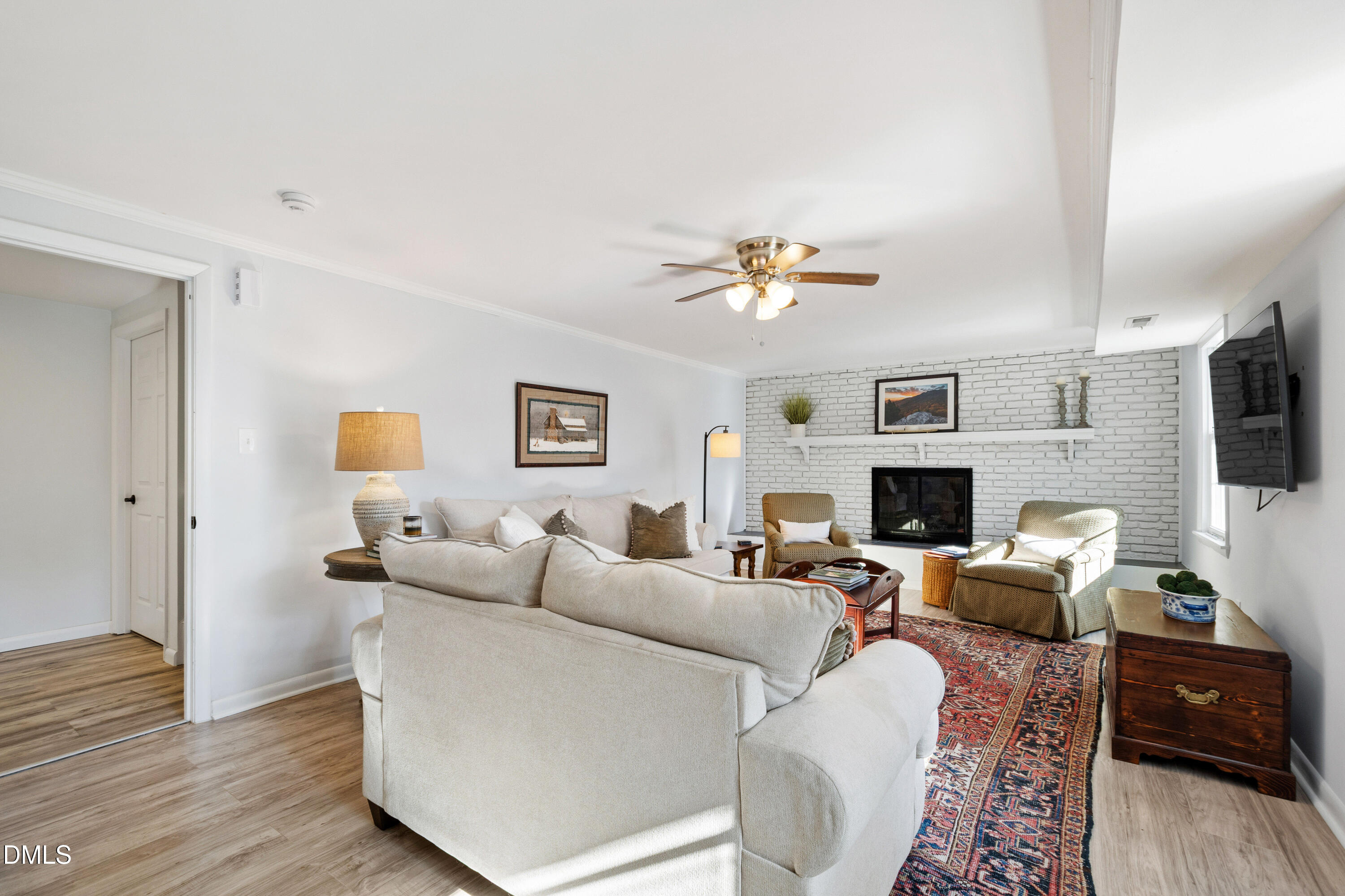 211 Northfield Drive Raleigh, NC 27609 - Photo 29 of 49 a living room with furniture a fireplace and a flat screen tv