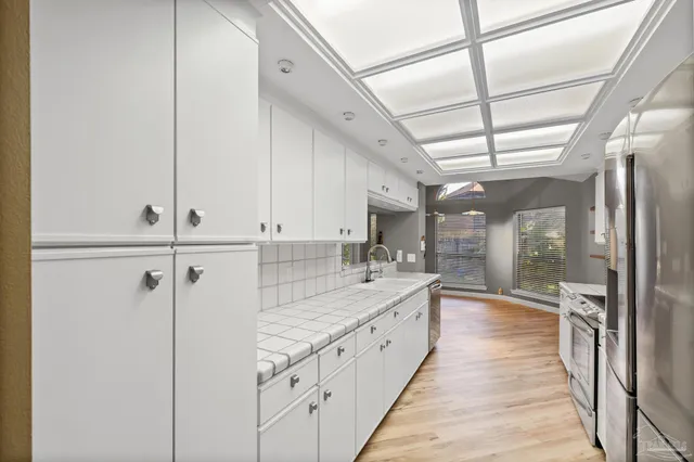 a kitchen with granite countertop a sink and a stove top oven