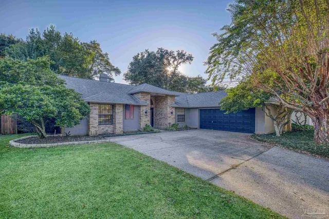 a view of a house with a yard and tree