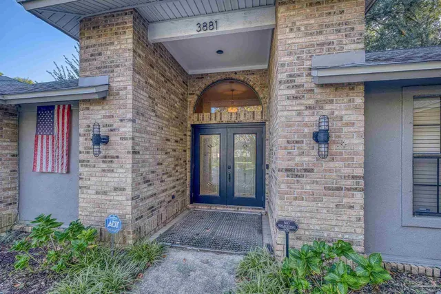 a front view of a building with potted plants