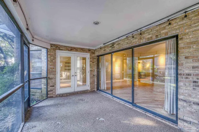 a view of an empty room with glass door