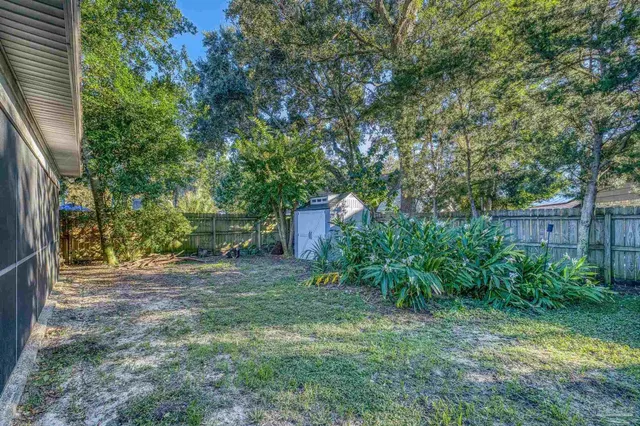 a backyard of a house with plants and outdoor seating