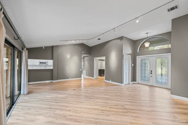 a view of a hallway with wooden floor