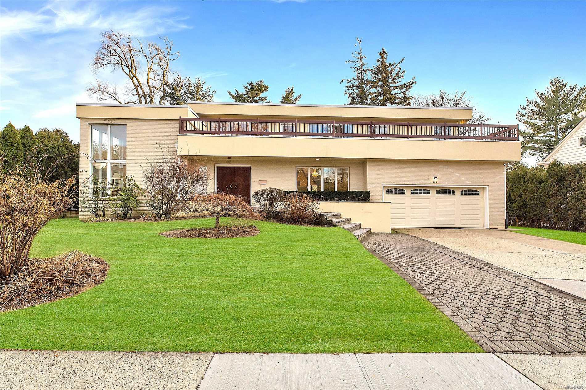 34 Beverly Road Great Neck, NY 11021 - Photo 1 of 1 a view of a patio with table and chairs potted plants and a palm tree