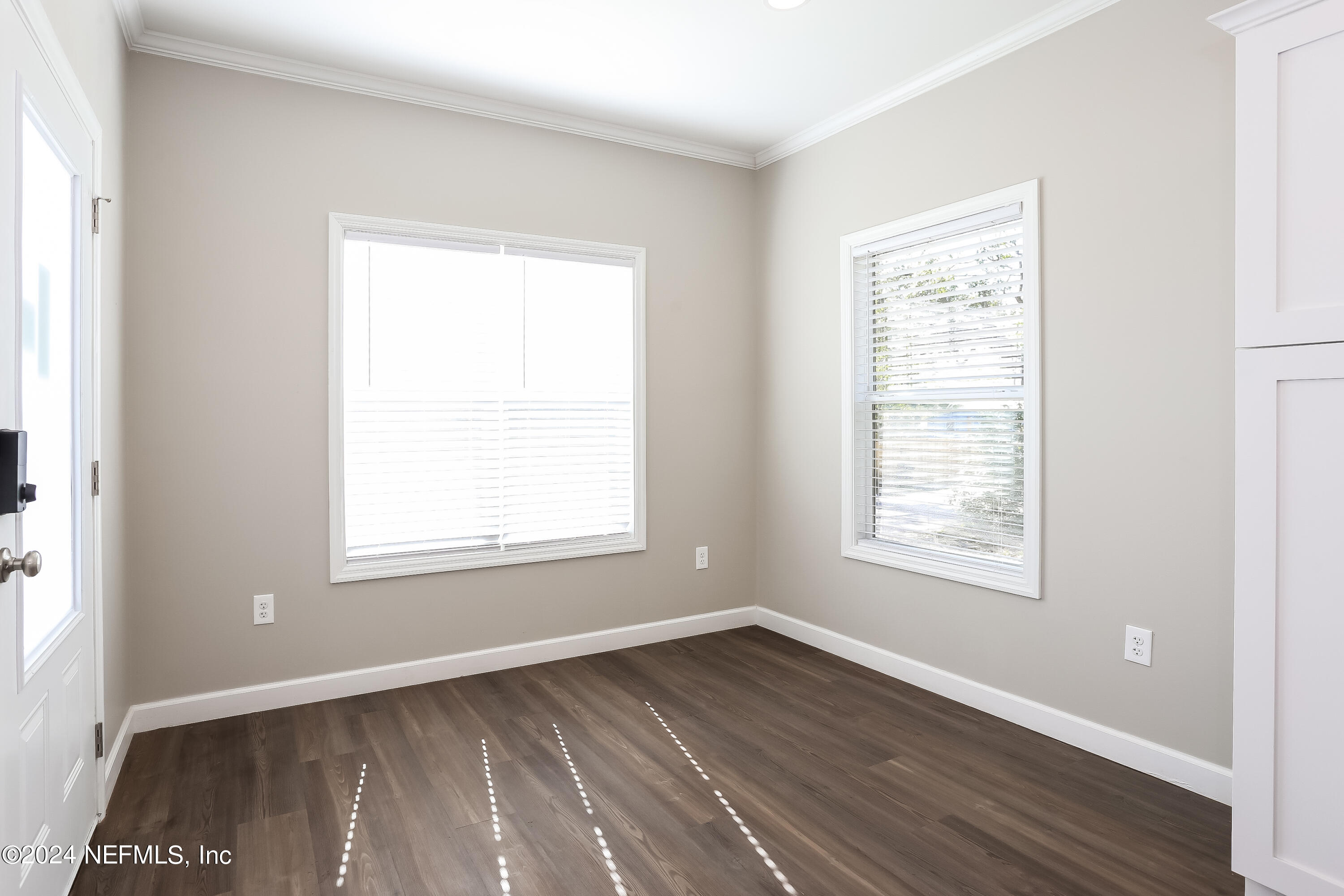 2119 Lewis Street Jacksonville, FL 32204 - Photo 3 of 14 an empty room with wooden floor and windows