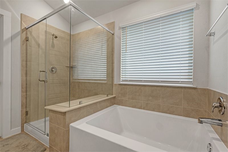 2643 Homestead Rnch Lane Crosby, TX 77532 - Photo 16 of 23 a bathroom with a bathtub and a shower