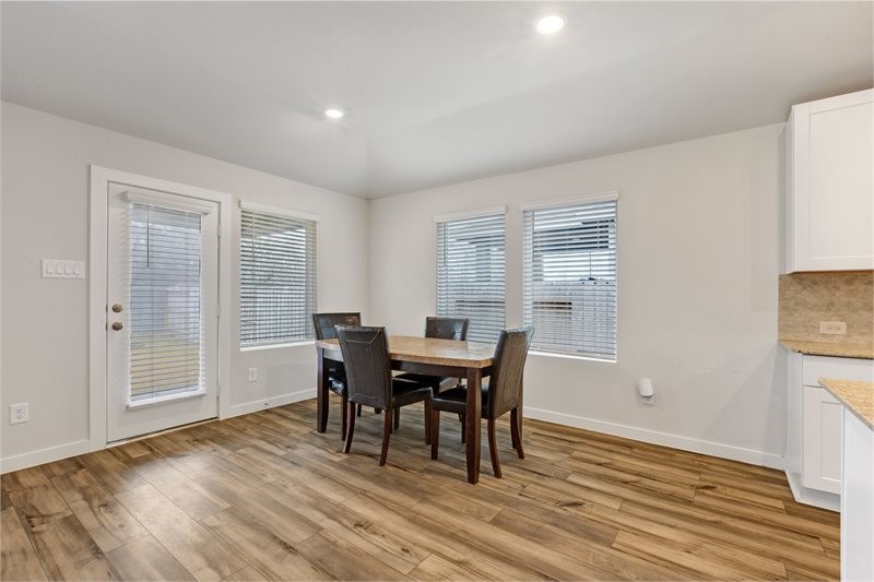 2643 Homestead Rnch Lane Crosby, TX 77532 - Photo 18 of 23 a view of a dining room with furniture and wooden floor