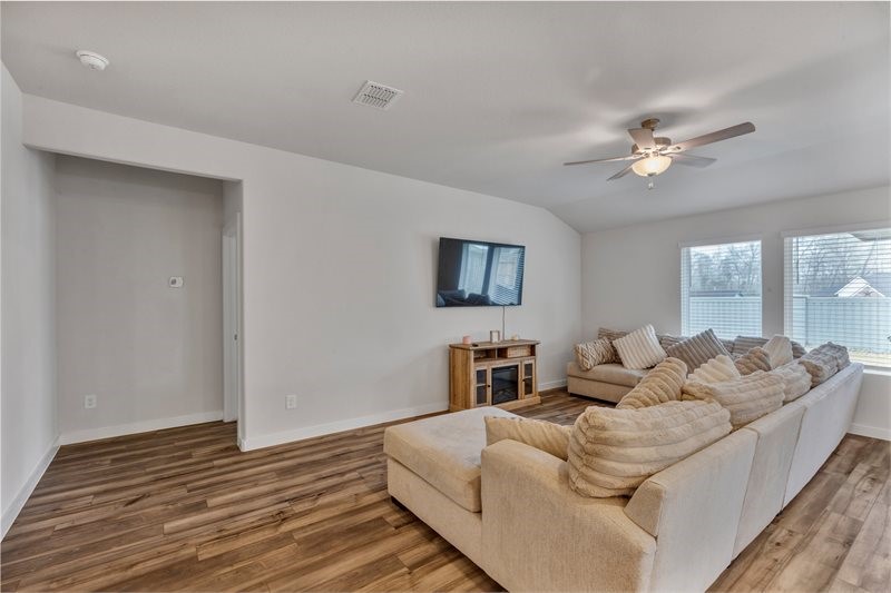 2643 Homestead Rnch Lane Crosby, TX 77532 - Photo 22 of 23 a living room with furniture ceiling fan and a wooden floor
