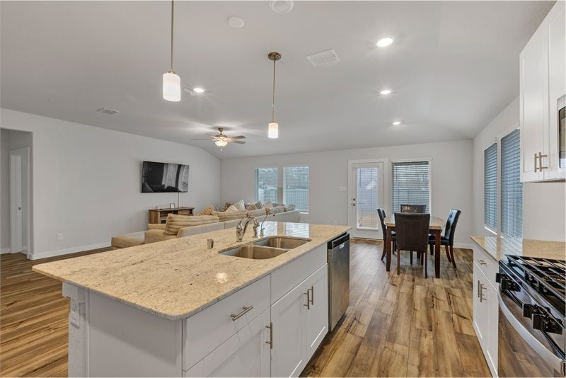 2643 Homestead Rnch Lane Crosby, TX 77532 - Photo 3 of 23 a large kitchen with kitchen island a sink table and chairs