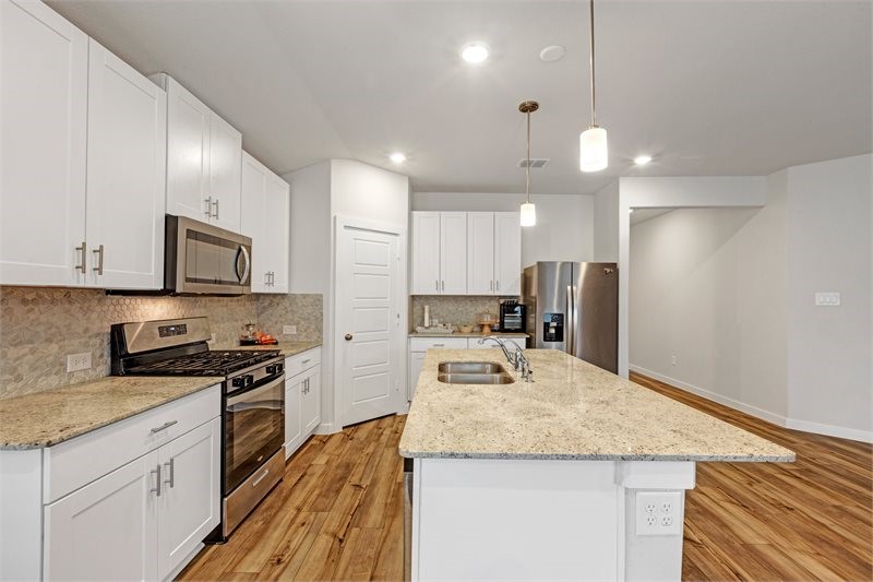 2643 Homestead Rnch Lane Crosby, TX 77532 - Photo 7 of 23 a kitchen with stainless steel appliances granite countertop a sink stove and refrigerator