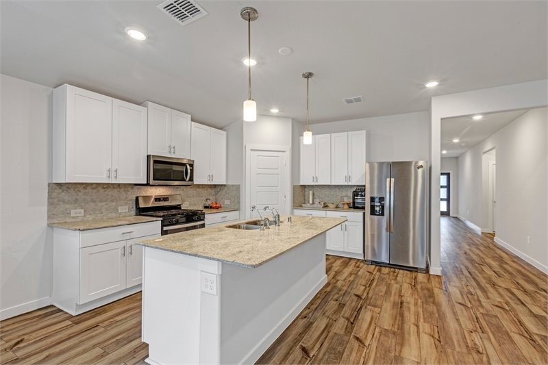 2643 Homestead Rnch Lane Crosby, TX 77532 - Photo 9 of 23 a kitchen with a sink a counter top space stainless steel appliances and cabinets