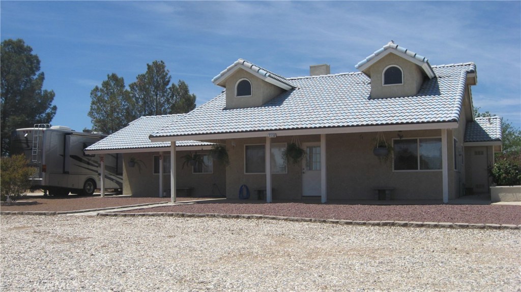 7230 Foley Road Oak Hills, CA 92344 - Photo 1 of 1 a front view of a house with a yard