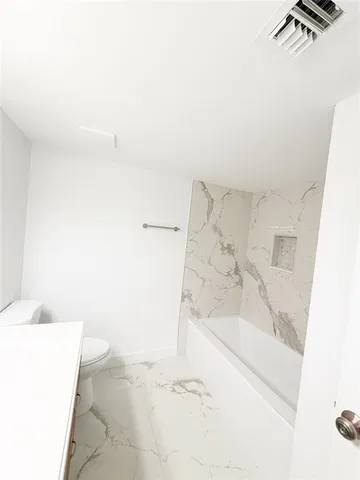 a bathroom with a bathtub and shower