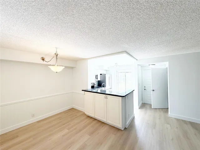 a kitchen with a sink cabinets and wooden floor